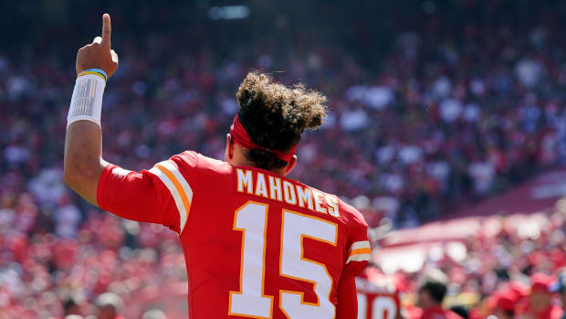 Sep 26, 2021; Kansas City, Missouri, USA; Kansas City Chiefs quarterback Patrick Mahomes (15) signals to fans against the Los Angeles Chargers before the start of the game at GEHA Field at Arrowhead Stadium. Mandatory Credit: Denny Medley-USA TODAY Sports